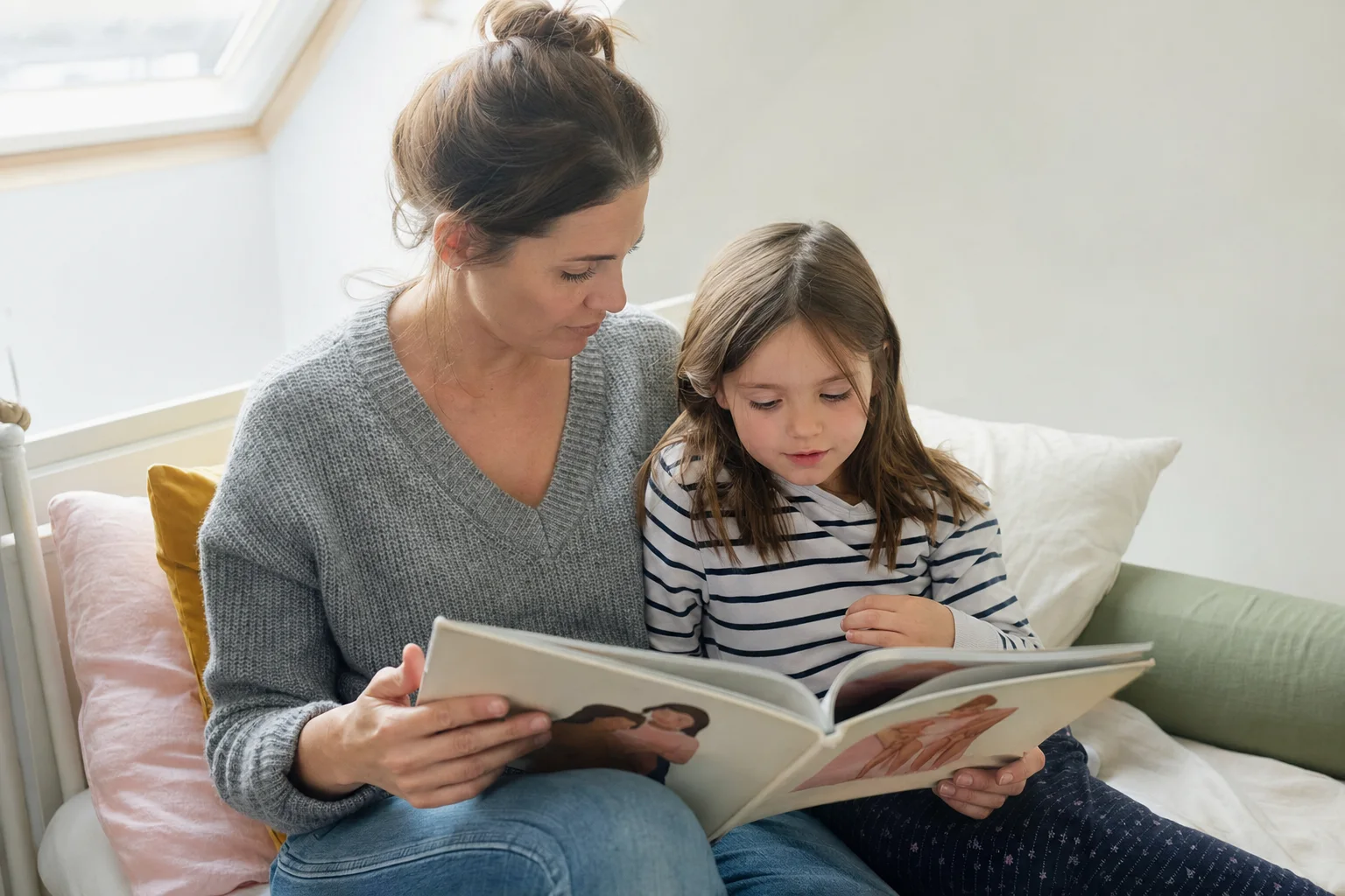 Elternteil liest dem Kind ein altersgerechtes Buch vor